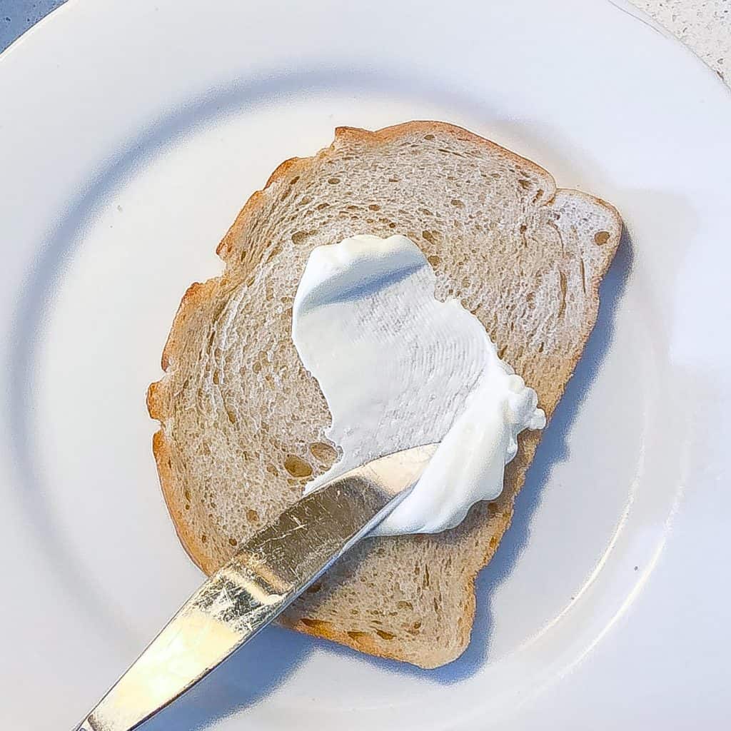 mayo being spread on bread