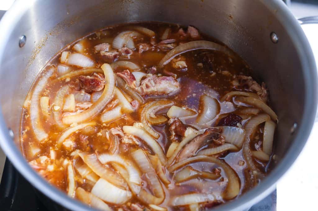onions and stock in pot