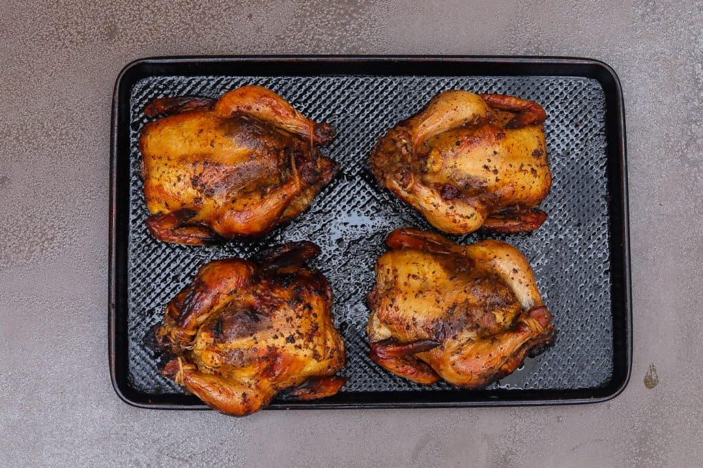 four cornish hens on a tray