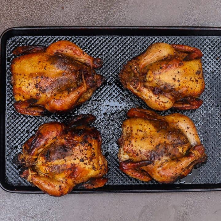 four cornish hens on a tray