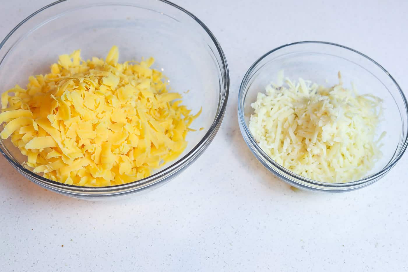 shredded cheese in clear bowls