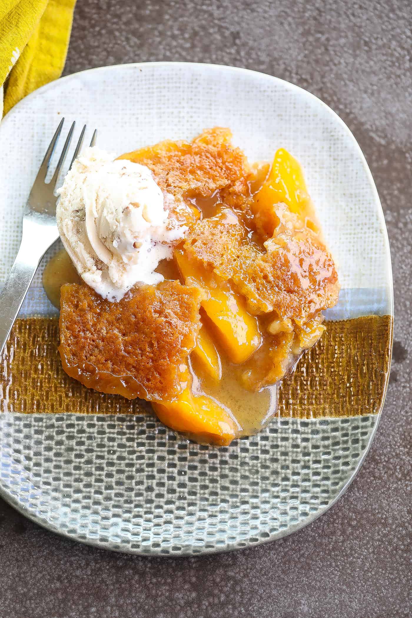 peach cobbler on a tri-color plate