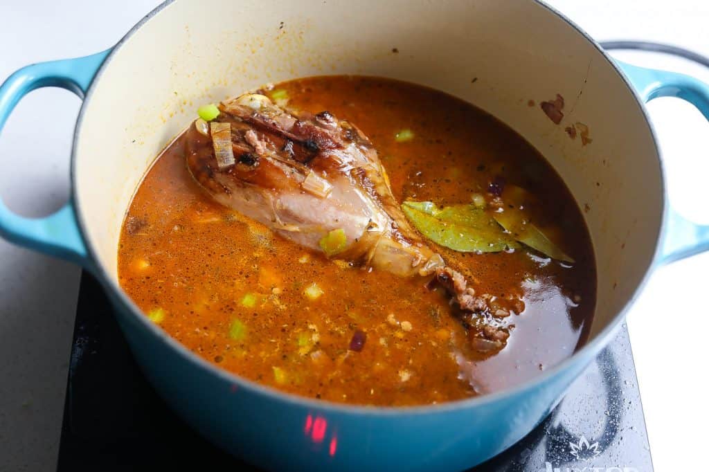 stock and turkey leg in pot