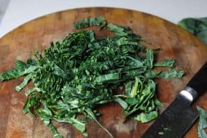 sliced collard green strips on cutting board