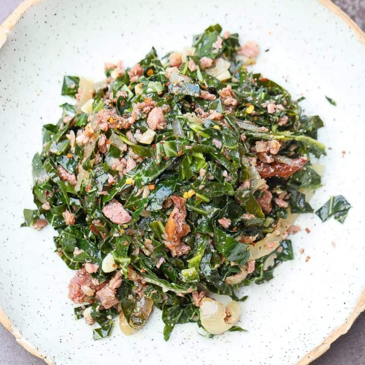 brazilian collard greens and turkey pices on a green plate