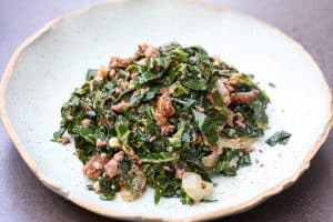 brazilian collard greens and turkey pices on a green plate