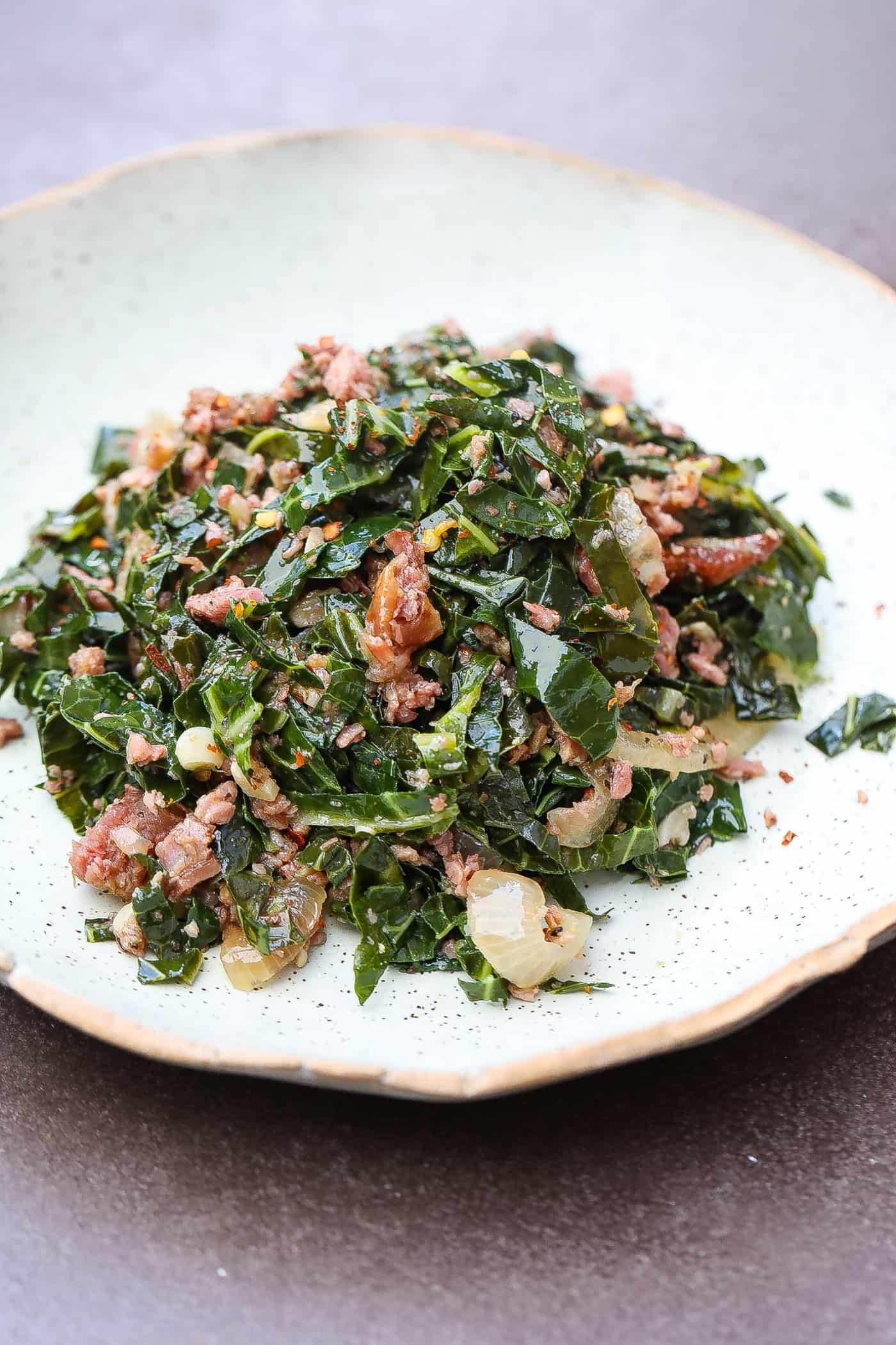 brazilian collard greens and turkey pices on a green plate