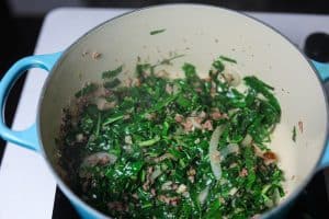 greens sauteing in pot