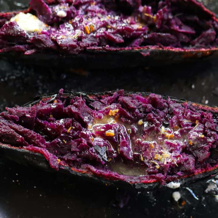 purple sweet potato halves on a black plate