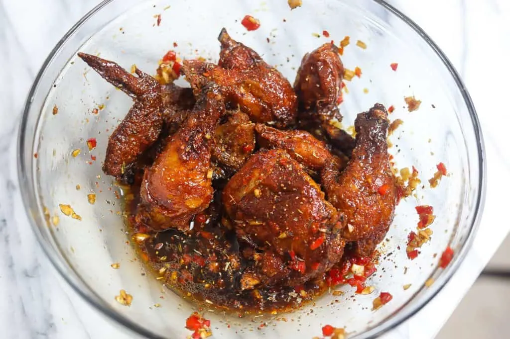 fried chicken in a bowl of sauce