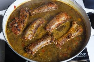smothered turkey necks in a white pan