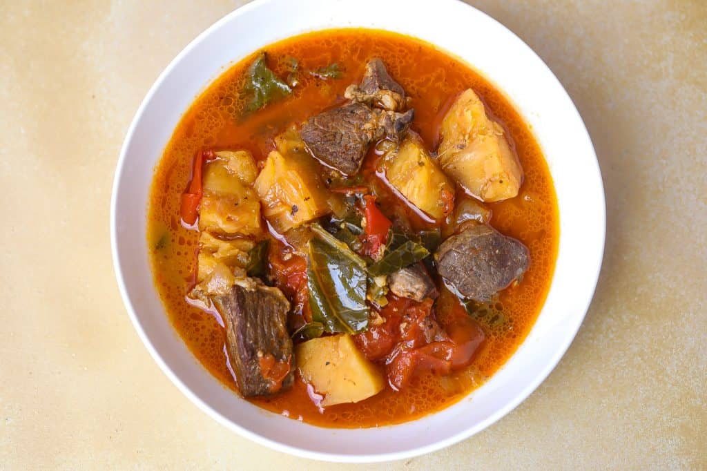 beef soup and vegetables in a white bowl