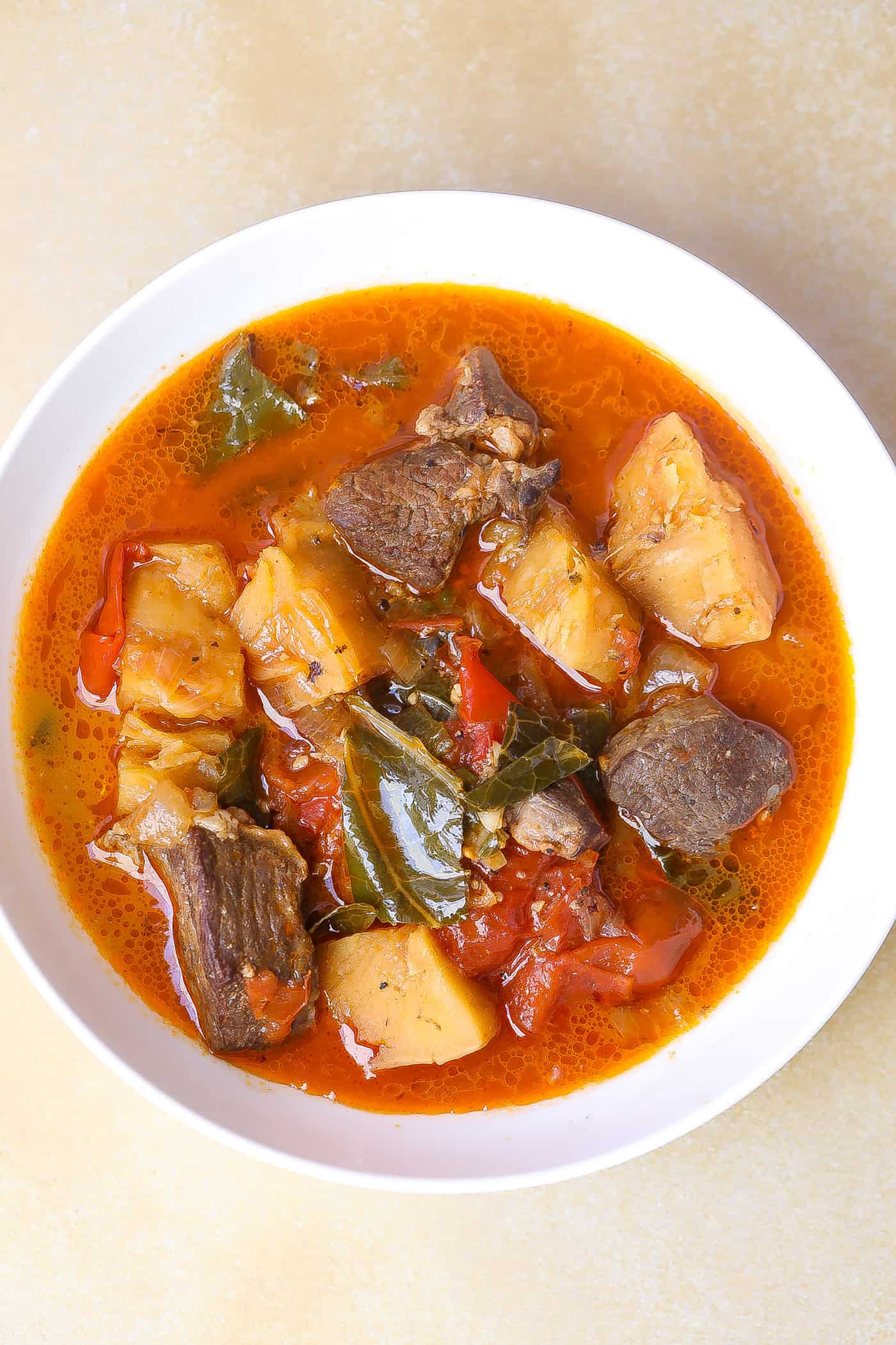 beef soup and vegetables in a white bowl