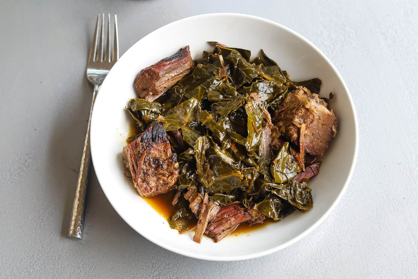 collard greens with brisket in bowl