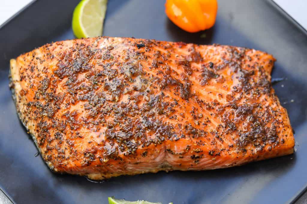 jerk salmon on a black plate