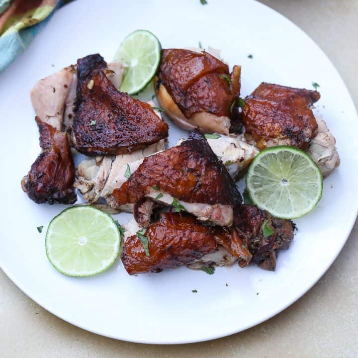 chunks of jamaican jerk chicken pieces on.a white plate