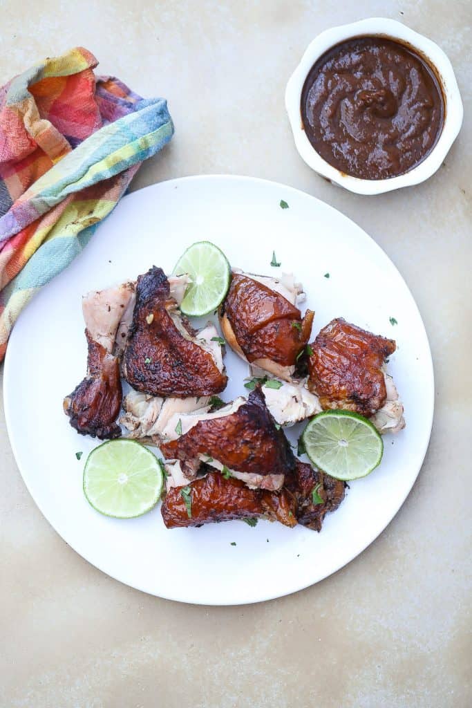 chunks of jamaican jerk chicken pieces on.a white plate