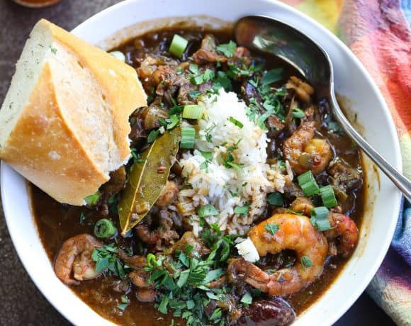 gumbo with rice and seafood in a white bowl
