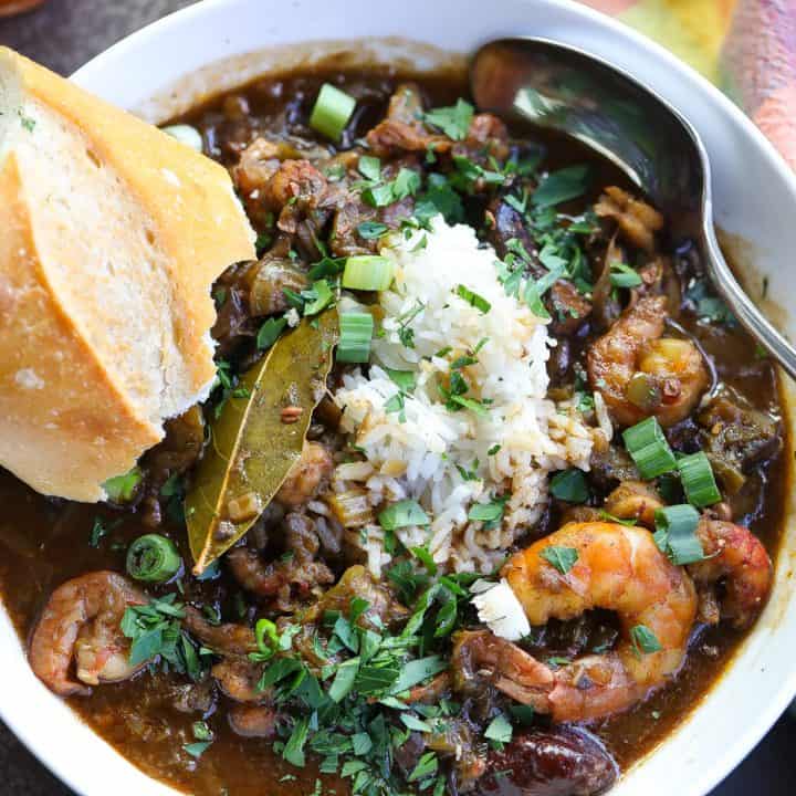 gumbo with rice and seafood in a white bowl