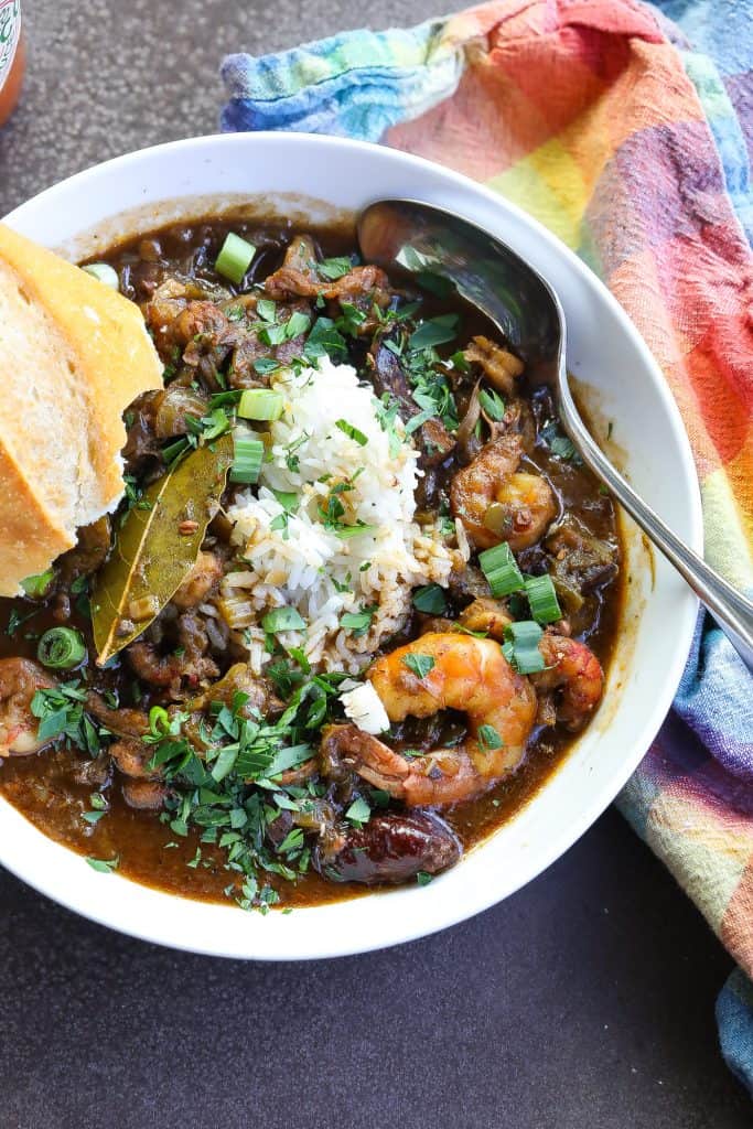 gumbo with rice and seafood in a white bowl