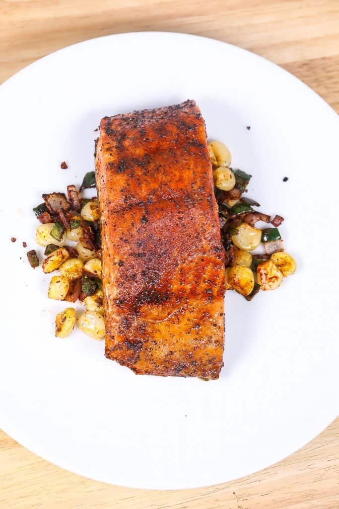 broiled salmon with corn on a white plate