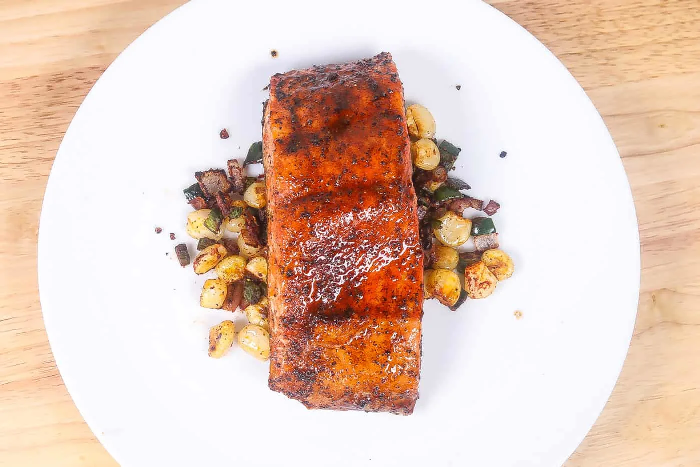 broiled salmon with corn on a white plate