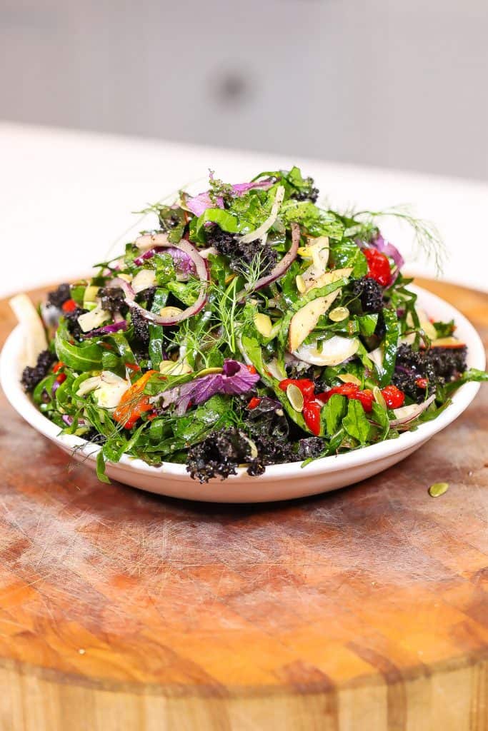 collard green salad on a white plate