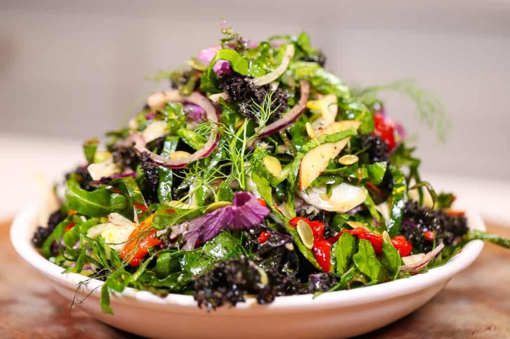 collard green salad on a white plate