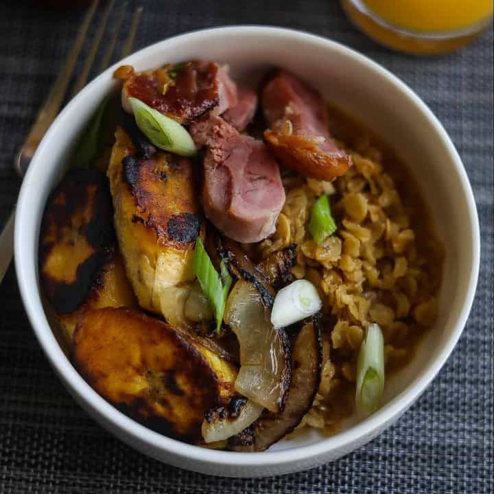 savory oatmeal topped with plantains, ham, and onions