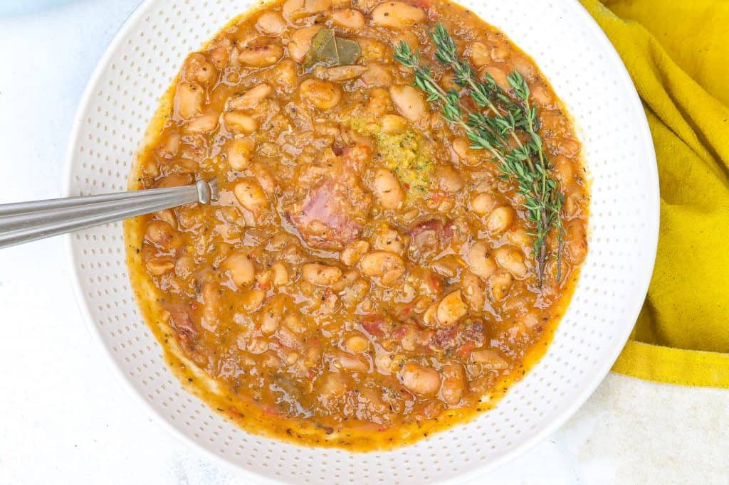 pinto beans with ham hocks in white bowl