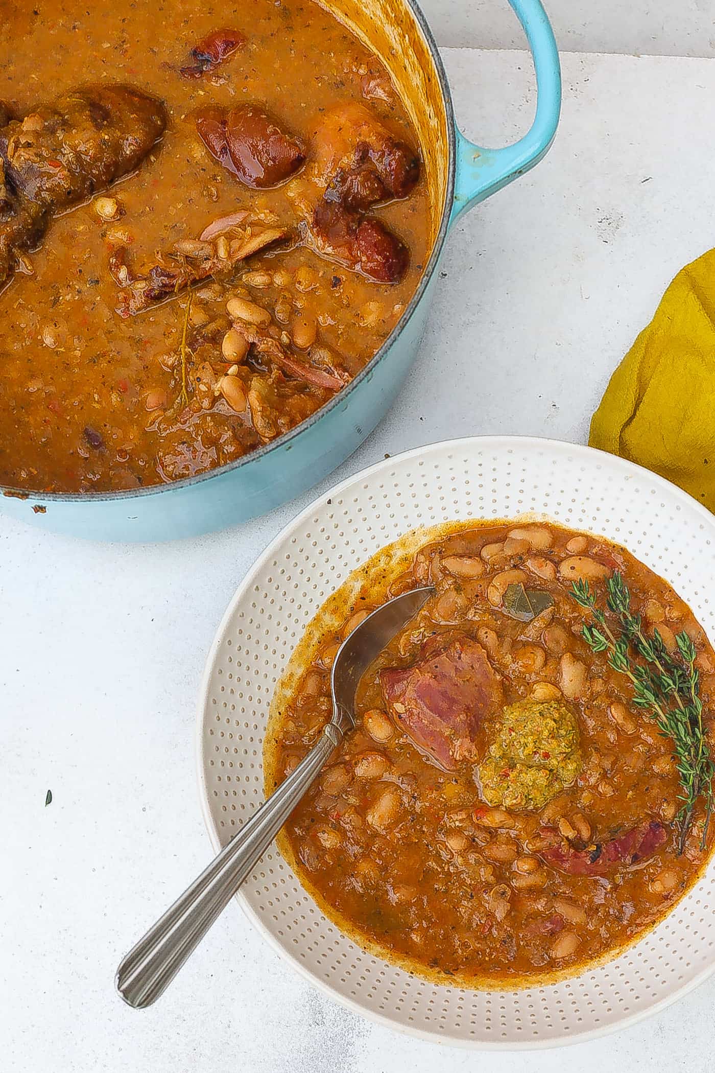 pinto beans with ham hocks in white bowl