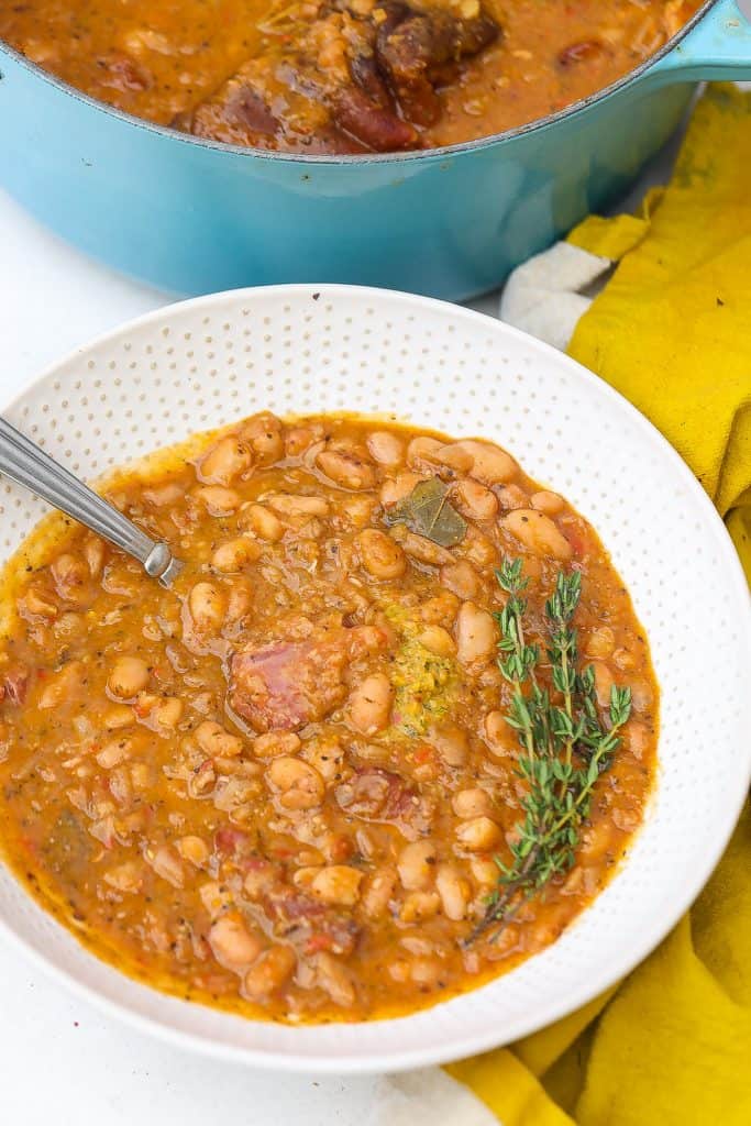 pinto beans with ham hocks in white bowl