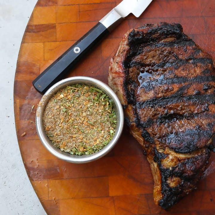 grilled steak on a cutting board with jerk seasoning