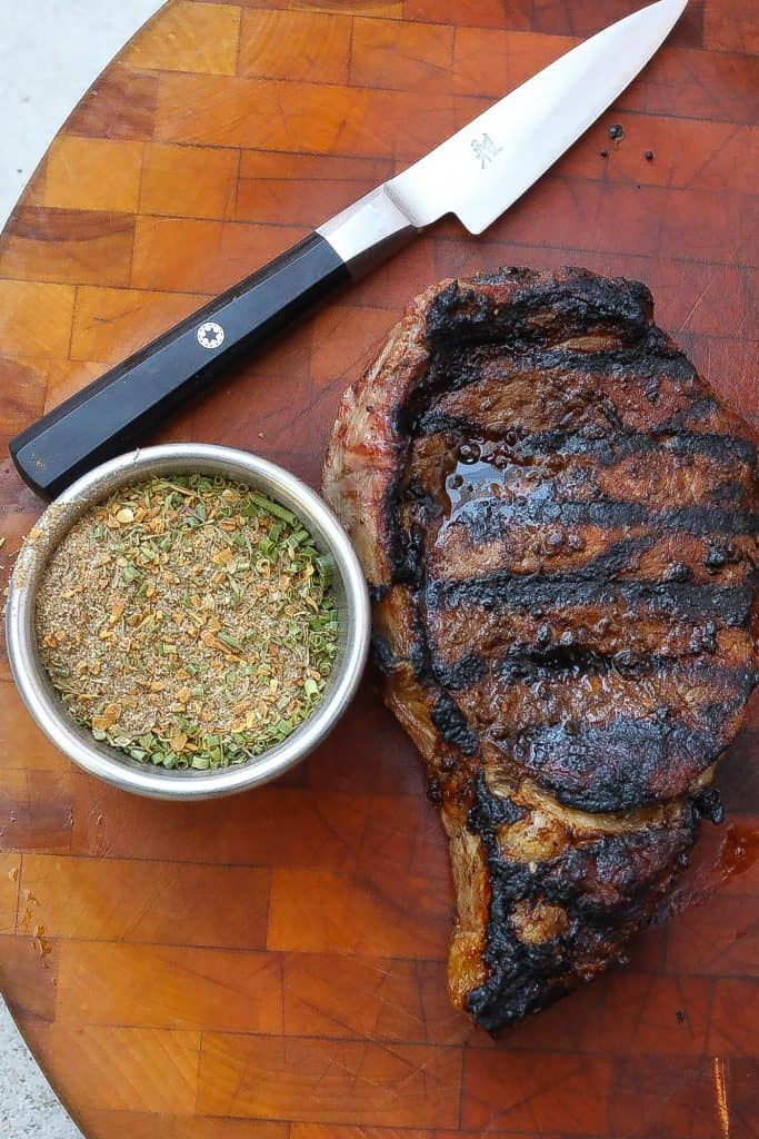 grilled steak on a cutting board with jerk seasoning