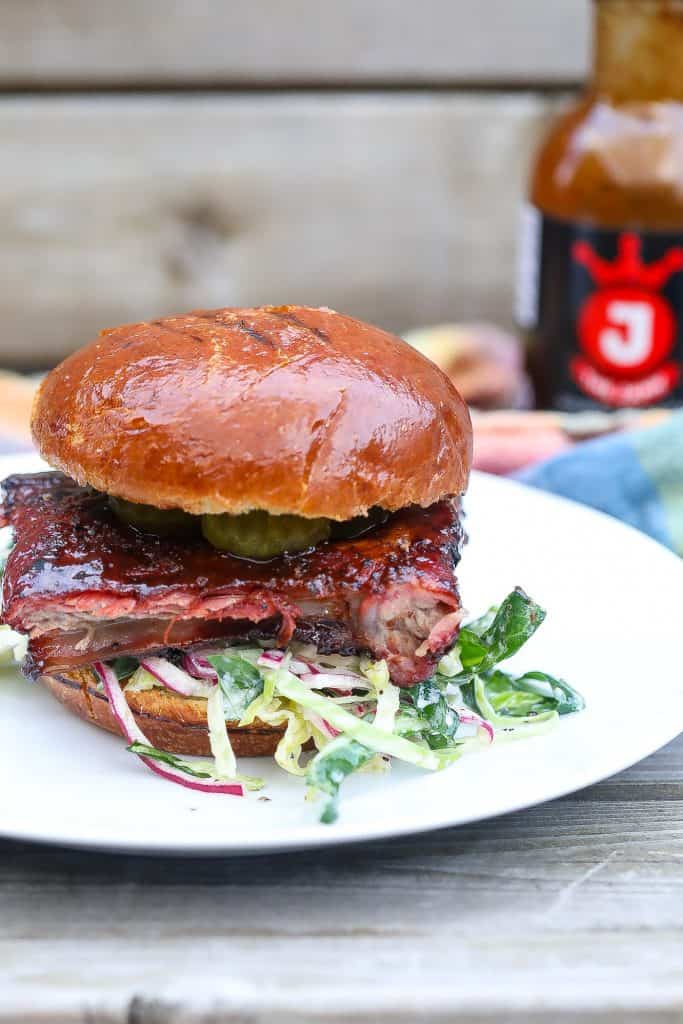 smoked rib sandwich on white plate