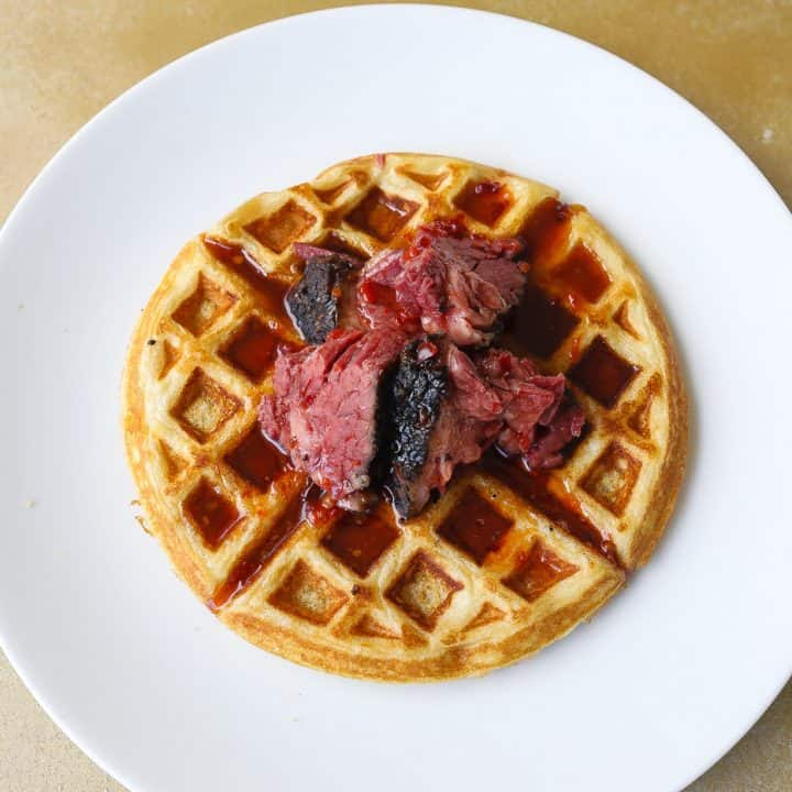 buttermilk waffle topped with smoked brisket and spicy syrup