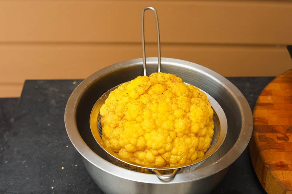 yellow cauliflower draining in a bowl