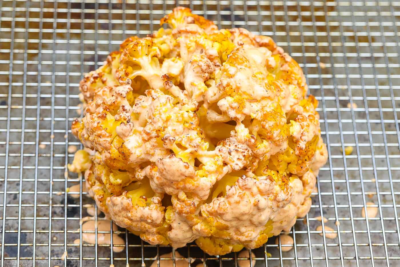 whole cauliflower topped with sauce