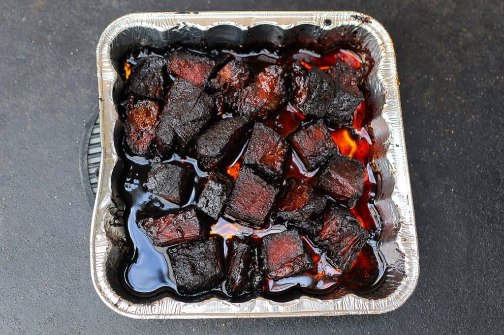 beef burnt ends in an aluminum pan