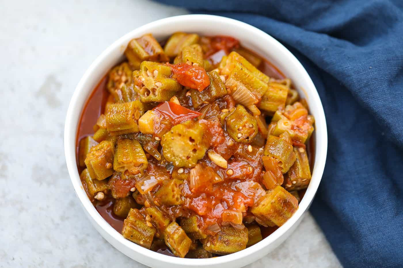 stewed okra and tomatoes in a white bowl