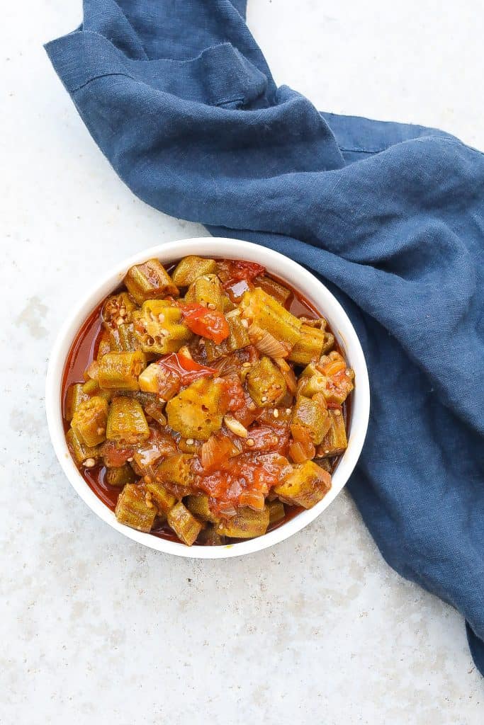 stewed okra and tomatoes in a white bowl