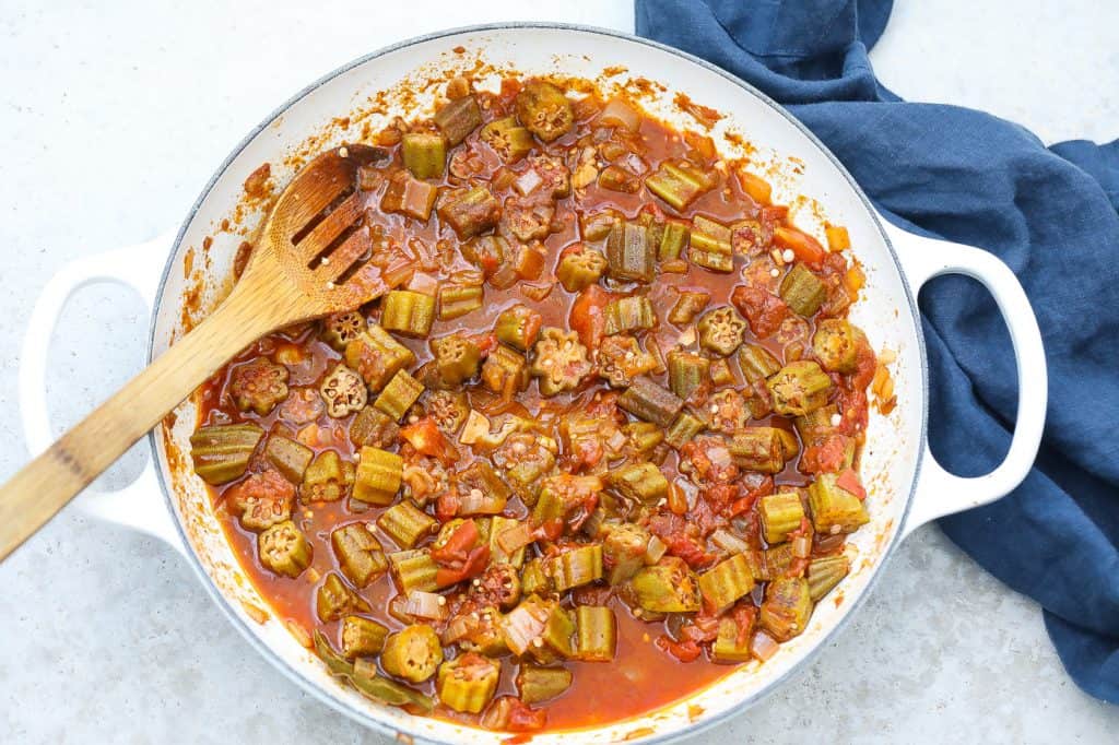 stewed okra and tomatoes in a white pan