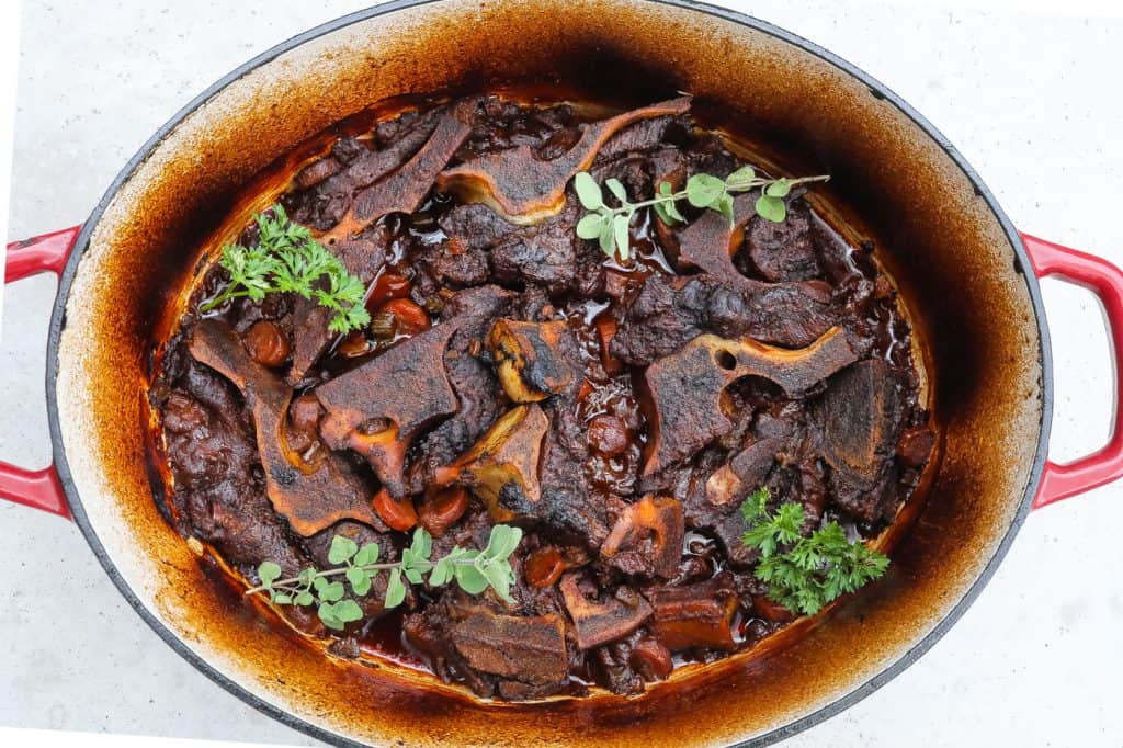 beef neck bones braising in a pot