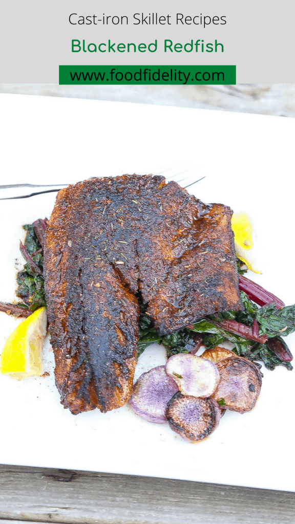 blackened fish on top of greens