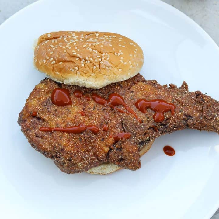 fried pork with bun on white plate