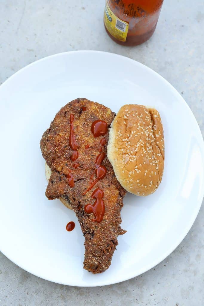 fried pork with bun on white plate