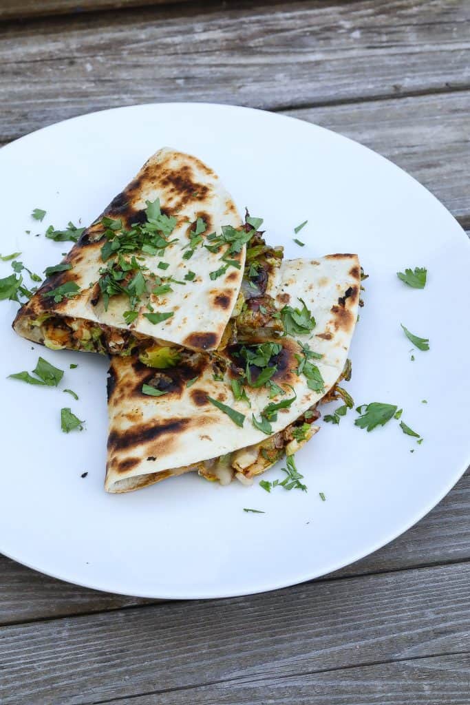 brussels sprouts quesadillas stacked on a plate