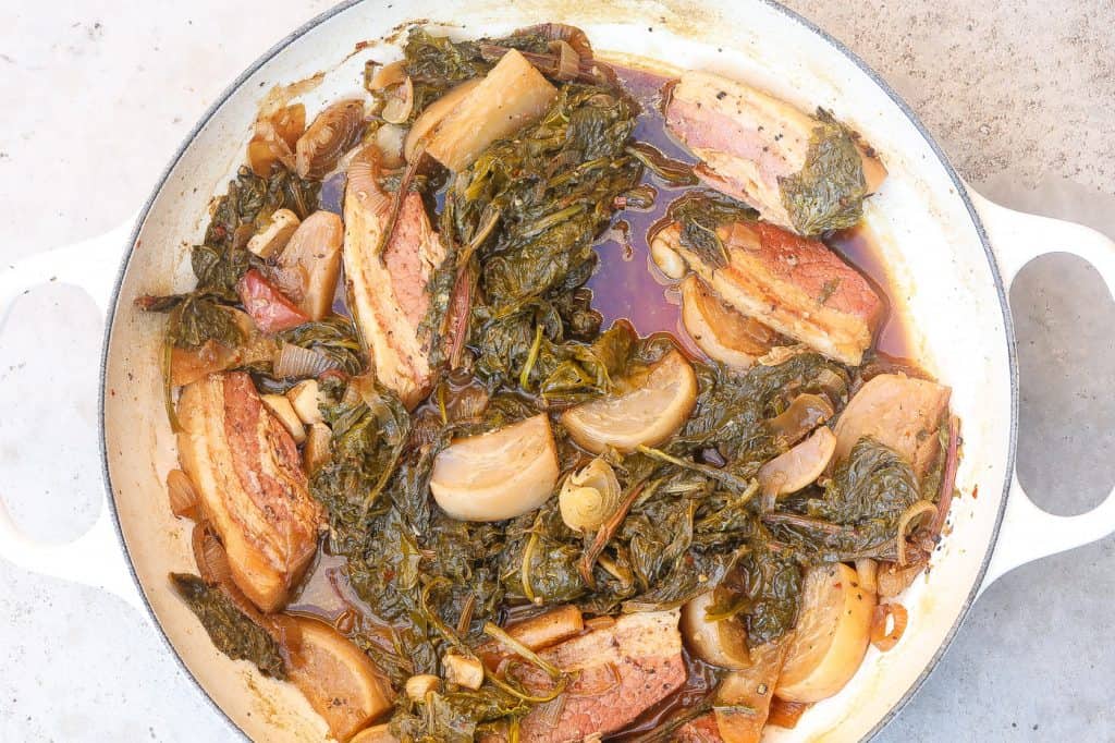 turnip greens with salt bacon and turnip roots in white pot