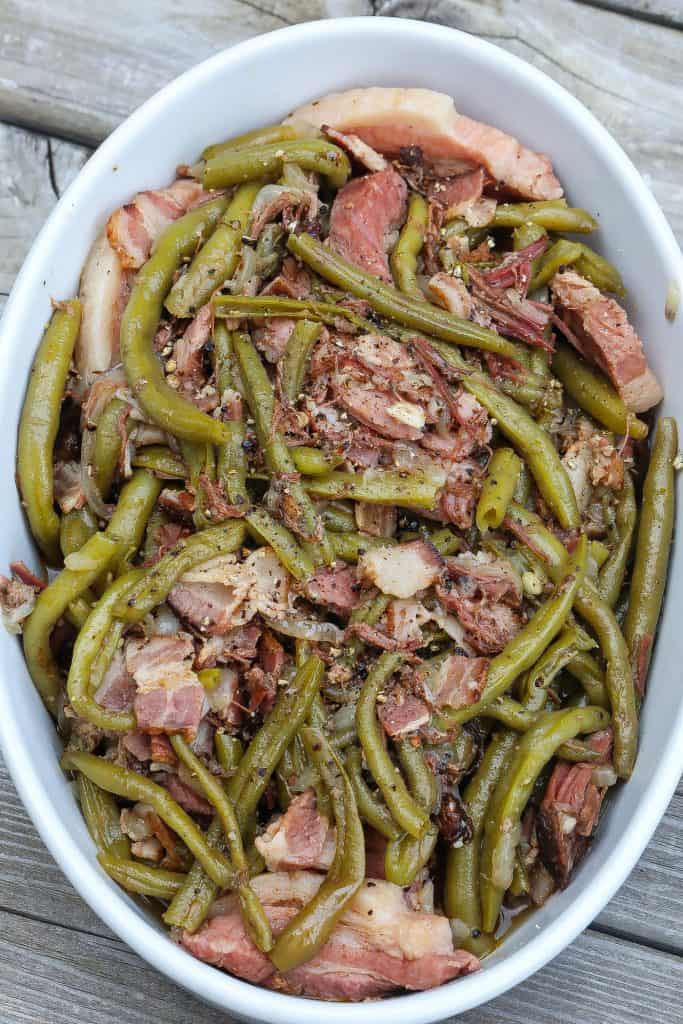 green beans and bacon in white oval bowl