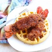 fried lobster tails on top of waffles